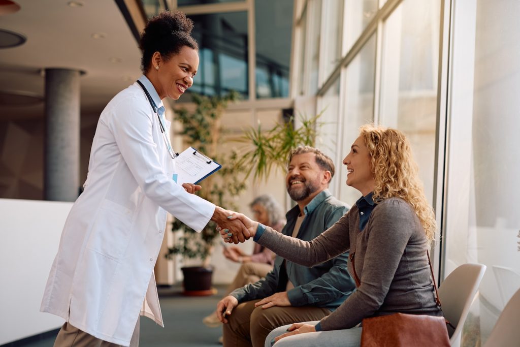 Doctor warmly greeting patients at a behavioral health clinic