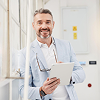 Male healthcare professional holding a tablet in a clinical setting